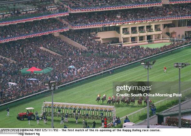 THE FIRST RACE AT THE RE-OPENING OF THE HAPPY VALLEY RACECOURSE GETS UNDER WAY IN FRONT OF A PACKED STAND ON 25 NOVEMBER 1995. AFTER A FULL CIRCUIT...