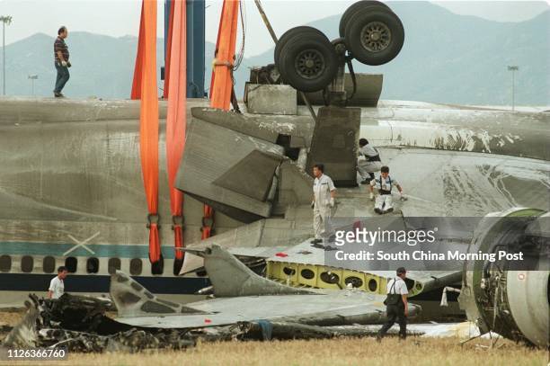 Engineers prepare the crashed China Airlines plane for removal from the tarmac at Chek Lap Kok Airport. The plane will be moved to a clear area at...