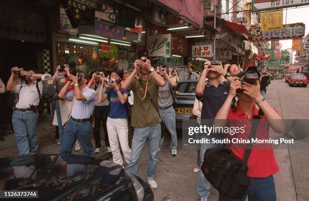 Crowds at Kowloon City taking pictures of the airplanes landing at Kai Tak airport in the last hours of the airport. 4 jul 98