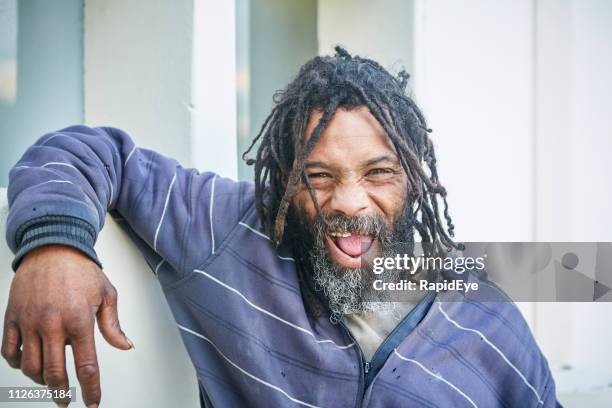 homeless man leaning on wall laughing - funny toothless stock pictures, royalty-free photos & images
