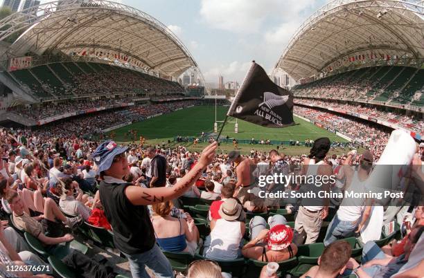 New Zealander waving an All Blacks flag in the Hong Kong Rugby Sevens at the Hong Kong Stadium. 27 March 1999