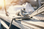 Mooring rope and bollard at the touristic harbor: vacations and yatching concept