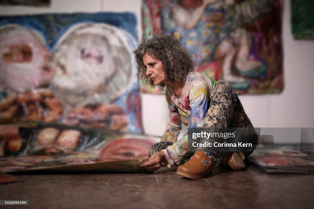 Woman arranging her artwork