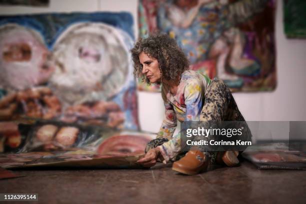 Woman arranging her artwork
