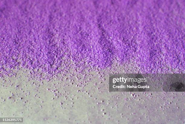 splashes of purple powder paint on a purple background - delhi smog stock pictures, royalty-free photos & images