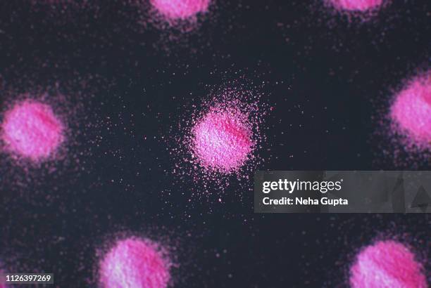 splashes of pink powder paint on a black background - delhi smog stock pictures, royalty-free photos & images