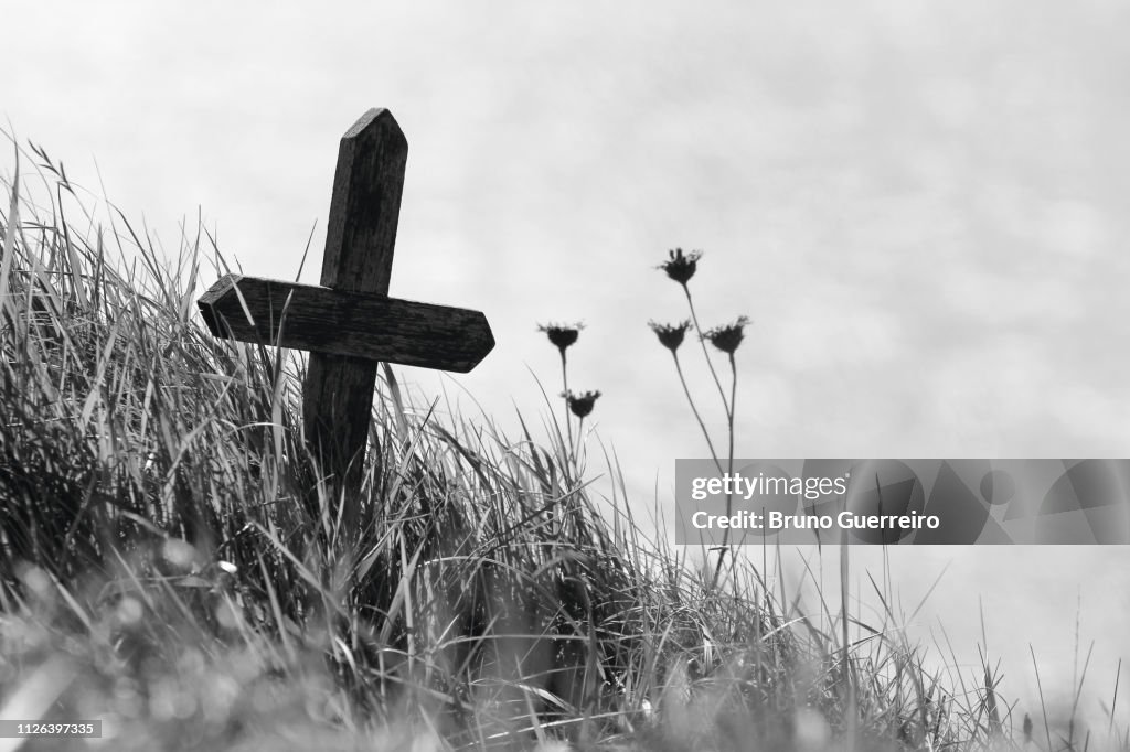 Wooden cross on the edge of a cliff