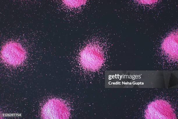 splashes of pink powder paint on a black background - delhi smog stock pictures, royalty-free photos & images