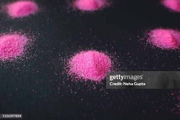 splashes of pink powder paint on a black background - delhi smog stock pictures, royalty-free photos & images