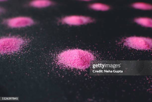 splashes of pink powder paint on a black background - delhi smog stock pictures, royalty-free photos & images