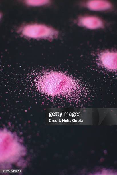 splashes of pink powder paint on a black background - delhi smog stock pictures, royalty-free photos & images