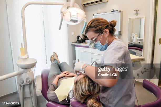 Female dentist examines a patient in a dental clinic