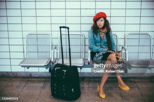 stylish lady with suitcase in subway station - waiting stock-fotos und bilder