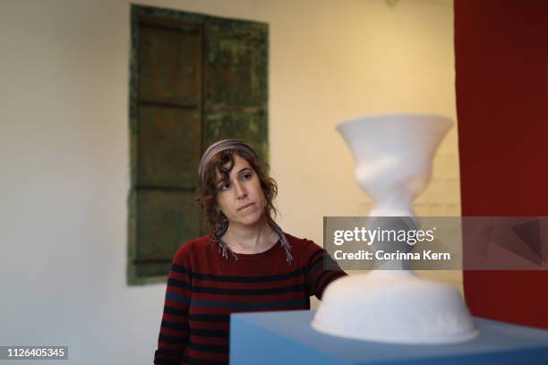 woman artist looking at ceramics sculpture in gallery - giudaismo foto e immagini stock