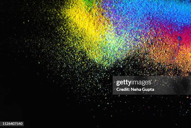 colourful powder paint explosion against a black background - colored powder stock pictures, royalty-free photos & images