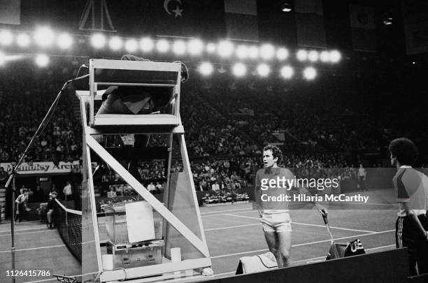 American tennis player John McEnroe talking to a referee during the final at Benson & Hedges Championships, Wembley Arena, London, UK, 16th November...