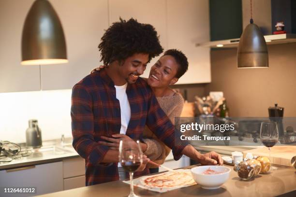young couple cooking at home and celebrating saint valentine - valentines couple stock pictures, royalty-free photos & images