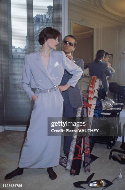 Karl Lagerfeld fits one of his designs on top model Ines de la Fressange at Chloe's Paris studio.