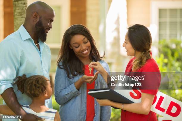 real estate agent and family looking at new home to purchase. - estate agent sign stock pictures, royalty-free photos & images