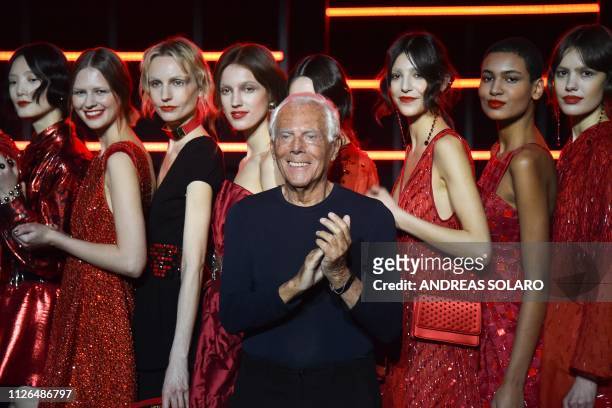 Italian fashion designer Giorgio Armani acknowledges applause following the presentation of the Emporio Armani women's Fall/Winter 2019/2020...