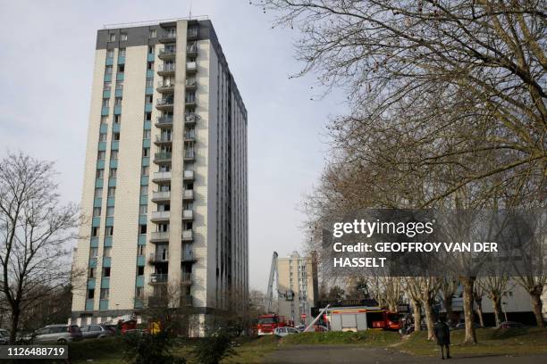 Firemen work in a building of Aulnay-sous-Bois, northern Paris on February 21, 2019 after a fire killed an elderly woman.