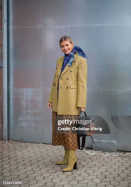 Janka Polliani is seen wearing scarf, plaid blazer, Gucci skirt, Loewe bag, checked sock boots outside Munthe during the Copenhagen Fashion Week...