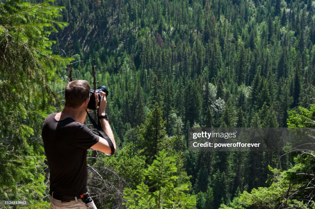 Tourist Photographing Mount Terry Fox Provincial Park in the Canadian Rocky Mountains, British Columbia, Canada