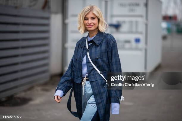 Xenia Adonts is seen wearing plaid coat, white bag, blue pants outside Munthe during the Copenhagen Fashion Week Autumn/Winter 2019 - Day 3 on...