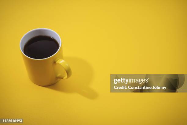 yellow coffee mug on yellow background. - breakfast no people stock pictures, royalty-free photos & images