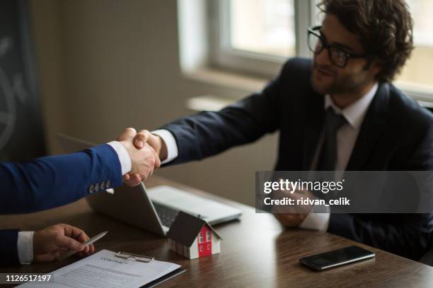 making real estate deal, handshake with agent - estate agency stock pictures, royalty-free photos & images