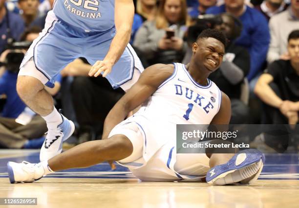 Zion Williamson of the Duke Blue Devils reacts after falling as his shoe breaks in the first half of the game against the North Carolina Tar Heels at...