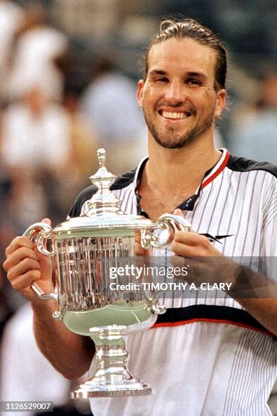 Pat Rafter Trophy Number three seeded Patrick Rafter of Australia holds the trophy ...