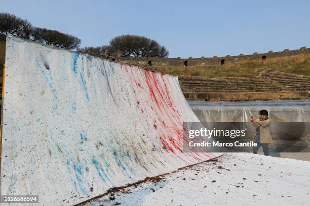 View of the artistic performance, after the explosion, "In The Volcano", by the artist Cai Guo Qiang, and paintings created by color powders and...