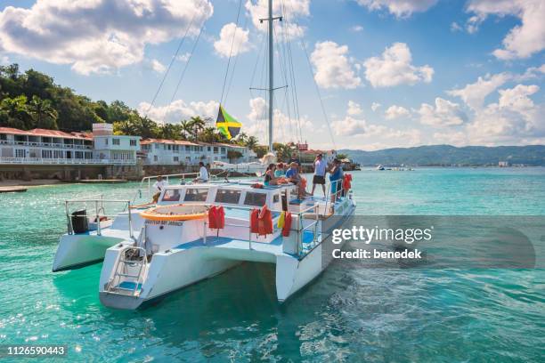 people enjoy boat tour in montego bay jamaica - jamaica flag stock pictures, royalty-free photos & images