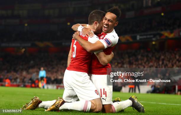 Sokratis of Arsenal celebrates scoring his teams third goal with teammate Pierre-Emerick Aubameyang during the UEFA Europa League Round of 32 Second...