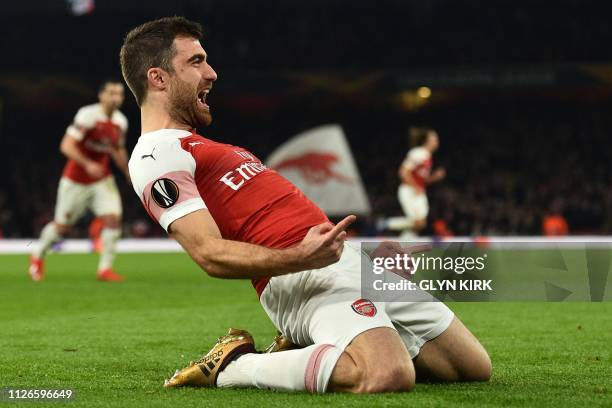 Arsenal's Greek defender Sokratis Papastathopoulos celebrates after scoring their third goal during the UEFA Europa League round of 32, 2nd leg...