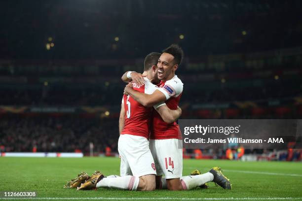 Sokratis Papastathopoulos of Arsenal celebrates with Pierre-Emerick Aubameyang after scoring a goal to make it 3-0 and 3-1 on Aggregate during the...