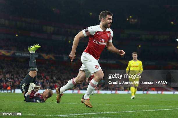 Sokratis Papastathopoulos of Arsenal celebrates after scoring a goal to make it 3-0 and 3-1 on Aggregate during the UEFA Europa League Round of 32...