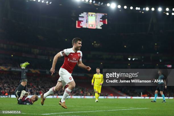 Sokratis Papastathopoulos of Arsenal celebrates after scoring a goal to make it 3-0 and 3-1 on Aggregate during the UEFA Europa League Round of 32...