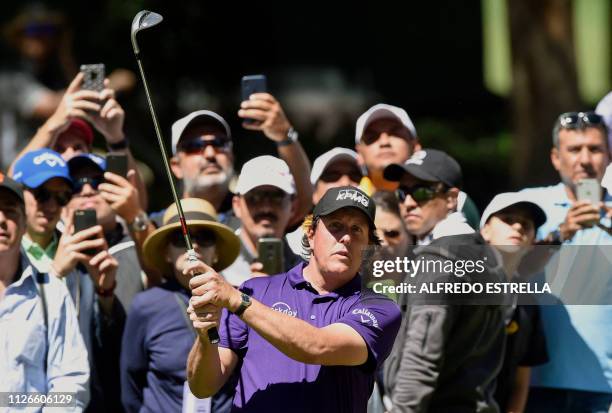 Golfer Phil Mickelson plays his shot on the tenth green, during the first round of the World Golf Championship, in Mexico City on February 21, 2019....