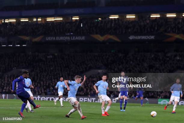 Chelsea's English midfielder Callum Hudson-Odoi shoots to score their third goal during the UEFA Europa League round of 32, 2nd leg football match...