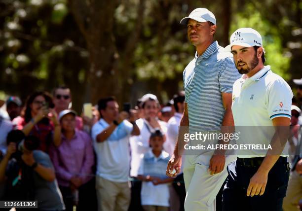 Golfer Tiger Woods and Mexican golfer Abraham Ancer walk to tee 3 during the first round of the World Golf Championship in Mexico City, at...