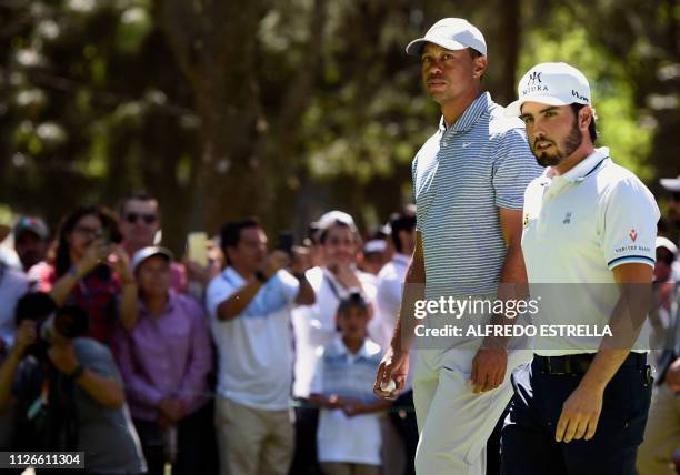 Golfer Tiger Woods and Mexican golfer Abraham Ancer walk to tee 3 during the first round of the World Golf Championship in Mexico City, at...