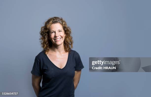 smiling mature female entrepreneur by empty space - curly hair isolated stock pictures, royalty-free photos & images