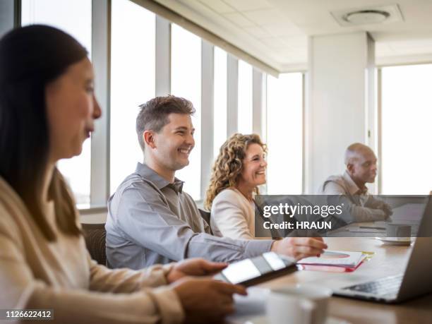smiling business colleagues in meeting at office - shareholders meeting stock pictures, royalty-free photos & images