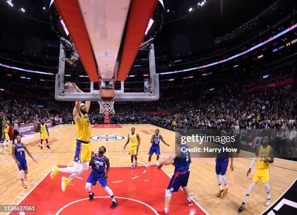 JaVale McGee of the Los Angeles Lakers prepares to dunk in front of Patrick Beverley and Boban Marjanovic of the LA Clippers during a 123-120 Laker...