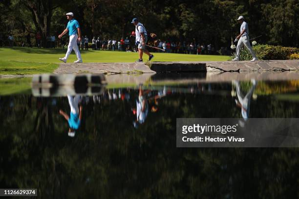 Byron DeChambeau and Tiger Woods of United States walk into the 6th tee during the first round of World Golf Championships-Mexico Championship at...