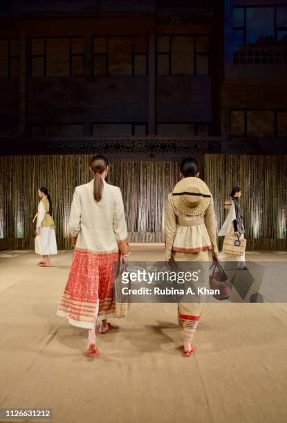 Models walk in garments created by fifteen Indian designers from textiles made by women from self-help groups across Asia at the World Bank...