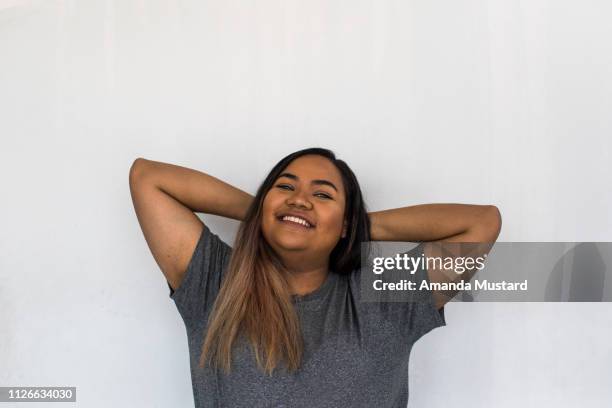 young mixed race woman smiling - voluptuous stock pictures, royalty-free photos & images