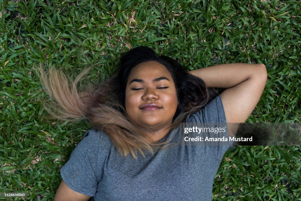 Young Mixed Race Woman Lying in the Grass